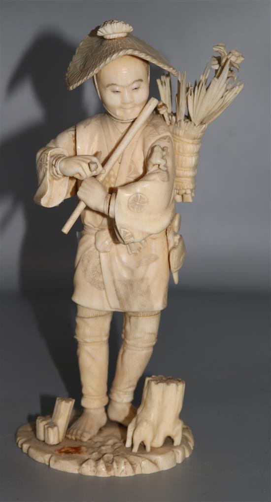A Japanese sectional ivory figure of a flower seller, early 20th century, 26.5cm A/F